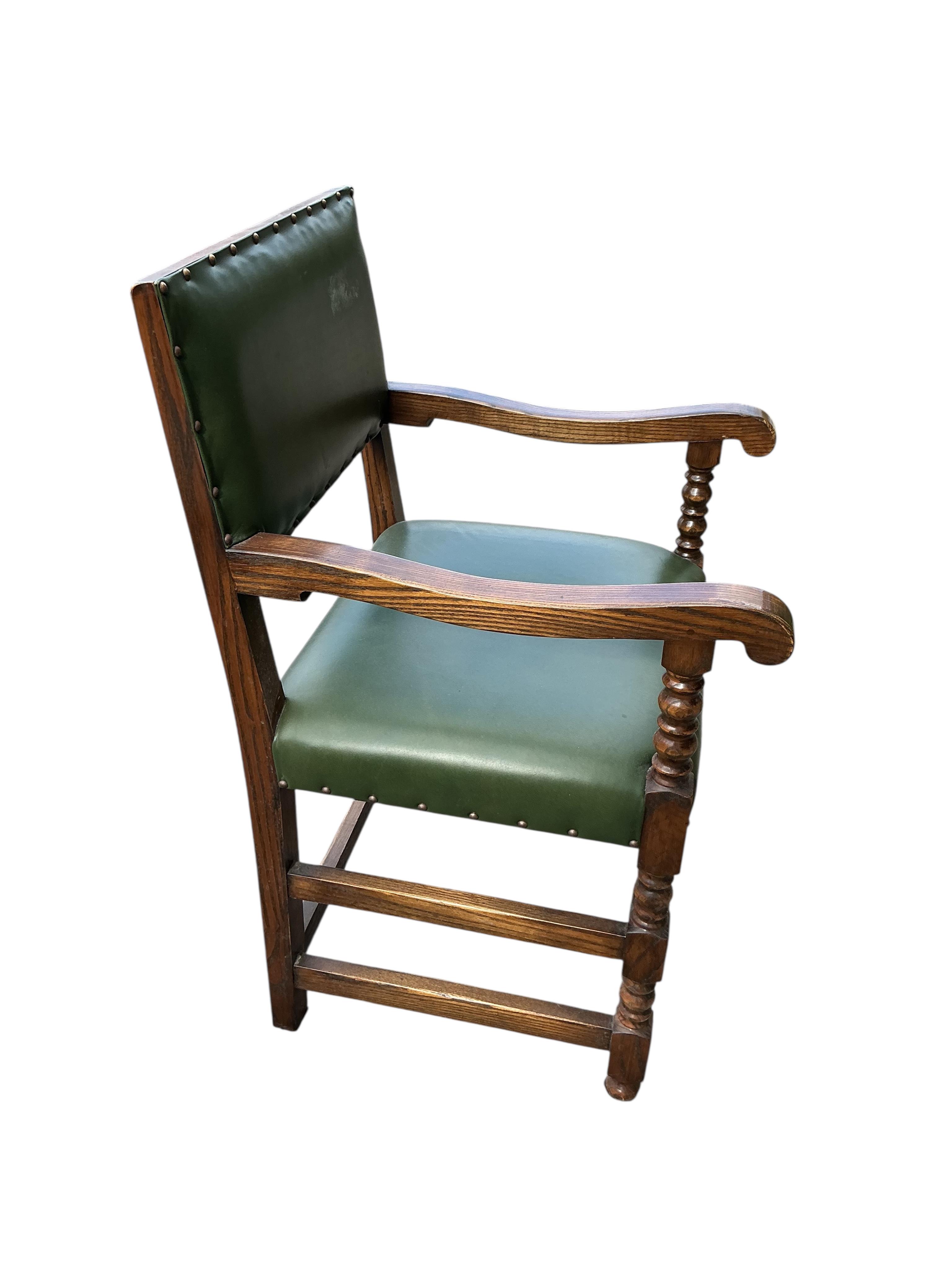 A set of twelve Bevan Funnel oak dining chairs, two with arms